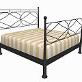 Double Bed With Black Metal Frame Ornate Design And Yellow White Striped Mattress