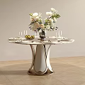 Elegant Round Dining Table With Fresh Flower Arrangement Wine Glasses And Fruits