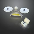Medical Instrument Featuring Dual White Discs Central Sphere Yellow Scale And Open Component Box