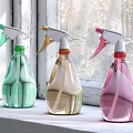 Colorful Plastic Spray Bottles on Window Sill for Home Cleaning Supplies