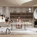 Public Office Space With Person At Desk Photography Equipment Shelves Bottles Lighting And Green Plants