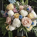 Colorful Mixed Flowers Arrangement In Black Vase With Gold Base And Green Leaves Ferns
