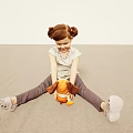 Little Girl with Pigtails Sitting on Floor Hugging Orange Stuffed Toy in Light Room