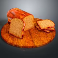 Fresh Brown Bread On Wooden Round Cutting Board With Whole Loaf And Sliced Pieces
