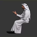 Man Sitting And Smiling In White Traditional Clothing With Headscarf Gesturing Against Gray Background
