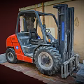 Red Industrial Forklift Utility Vehicle Featuring Large Tires For Warehouse Operations