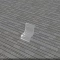 White Outdoor Chair Placed On Gray Wooden Floor With Shadow