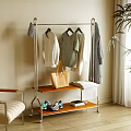 Stylish Metal Standing Clothes Rack With Hanging Shirts Sweaters Tote Bag And Sneakers On Shelves
