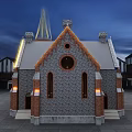 Historic Gothic Building With Spire Stone Brick Structure And Illuminated Arched Windows At Night