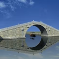 Ancient Stone Arch Bridge Over Calm Water With Reflection And Small Boat