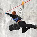 Man Rock Climbing On Wall With Safety Rope And Protective Gear
