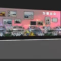 Car Show Event Setup With Red Background Screens White Vehicles And Flower Decorations