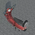 Red Scooter With Windshield And Black Seat On Gray Paved Surface