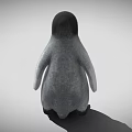Baby Penguin With Gray Body Black Head And Black Feet Standing On Gray Background