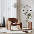 Brown Curved Accent Chair With Floor Lamp Round Clock Side Table And Green Plant In Modern Interior
