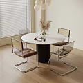 Round White Dining Table With Black Cylindrical Base Transparent Frame Chairs Brown Seats Dried Flower
