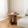 Walnut Wooden Round Top Side Table with White Cup and Pastry in Cozy Living Room