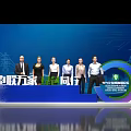 Group Photo Spot at International Energy Transition Forum With Power Towers Wind Turbines Stage Backdrop