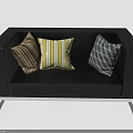 Black Sofa With Silver Metal Legs And Three Decorative Striped Geometric Pillows
