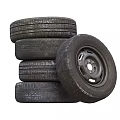 Car Tires Stacked with Silver Rims and Black Tread Patterns in Pile