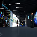 Modern High Tech Exhibition Hall With Screens Reception Desk And Lighting Design