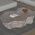 Irregular Shaped Marble Coffee Table With Open Book And Brown Bowl On Gray Rug