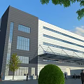 Modern Industrial Factory Building With Glass Windows Gray White Exterior And Greenery