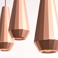 Three Copper Conical And Polygonal Pendant Lights Hanging On Textured Gray Wall
