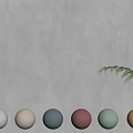 Textured Beige Wall with Various Color Swatches and Green Plant Foliage