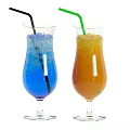 Two Refreshing Blue and Orange Drinks in Tall Glasses with Ice Cubes and Straws