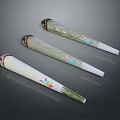 Three Conical Decorative Items With Green White Surface And Colorful Patterns
