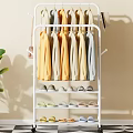 White Clothes Rack with Hanging Clothes and Shoe Shelves in Home Interior with Green Plant