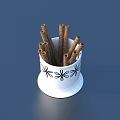 Everyday Household White Cup With Black Floral Patterns Holding Cinnamon Sticks