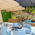 Modern Reception Area Interior With Green Floral Wall Blue Sofas And Armchairs