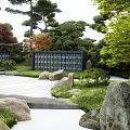 Traditional Karesansui Japanese Rock Garden with Raked Sand Stones Pine Trees and Green Foliage