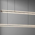 Modern Linear Chandelier with Golden Frame and Textured Shade Suspended in Contemporary Interior