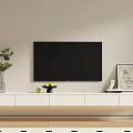 White TV Stand With Black TV Green Plant Fruit Bowl Artwork And Books