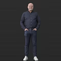 A Man In Dark Shirt And Jeans With Hands In Pockets Standing Against Dark Background