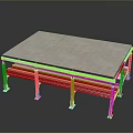 Modern Metal Frame Table With Gray Tabletop And Red Supports On Reflective Surface
