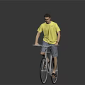 Man in yellow T-shirt and shorts riding a bicycle against gray background