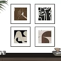 Four Framed Abstract Artworks On Wall With Wooden Cabinet And Decor Items