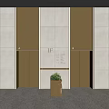 Modern Elevator Lobby With Golden Doors Stone Walls And Small Decorative Plant