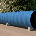 Construction Site Blue Corrugated Pipe with Support Blocks on Ground and Trees Background
