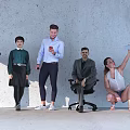 Group of People in Various Poses Standing Sitting and Interacting Against Concrete Wall