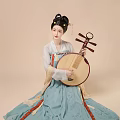 A Woman in Traditional Hanfu Playing Pipa with Ornate Hair Accessories
