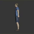 Man In Blue T Shirt And Blue Shorts Standing Against Gray Background