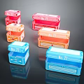 Colorful Storage Boxes with No77 Labels in Pink Orange Blue on Dark Reflective Surface