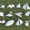White Tensile Membrane Structures in Outdoor Grass Field With Various Geometric Shapes