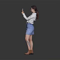 A Woman Wearing White Shirt And Blue Denim Skirt Using Smartphone Against Gray Reflective Floor