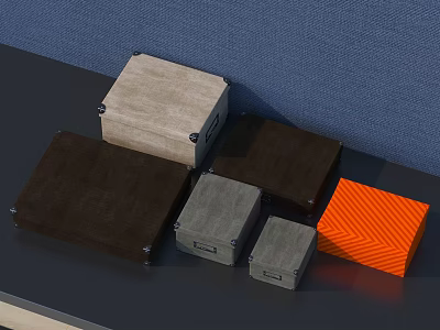 Decorative Ornament Set With Brown Beige Grey Orange Textured Boxes On Dark Tabletop Blue Wall 3d model
